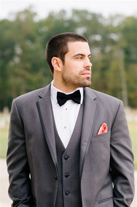 grey suit black bow tie.